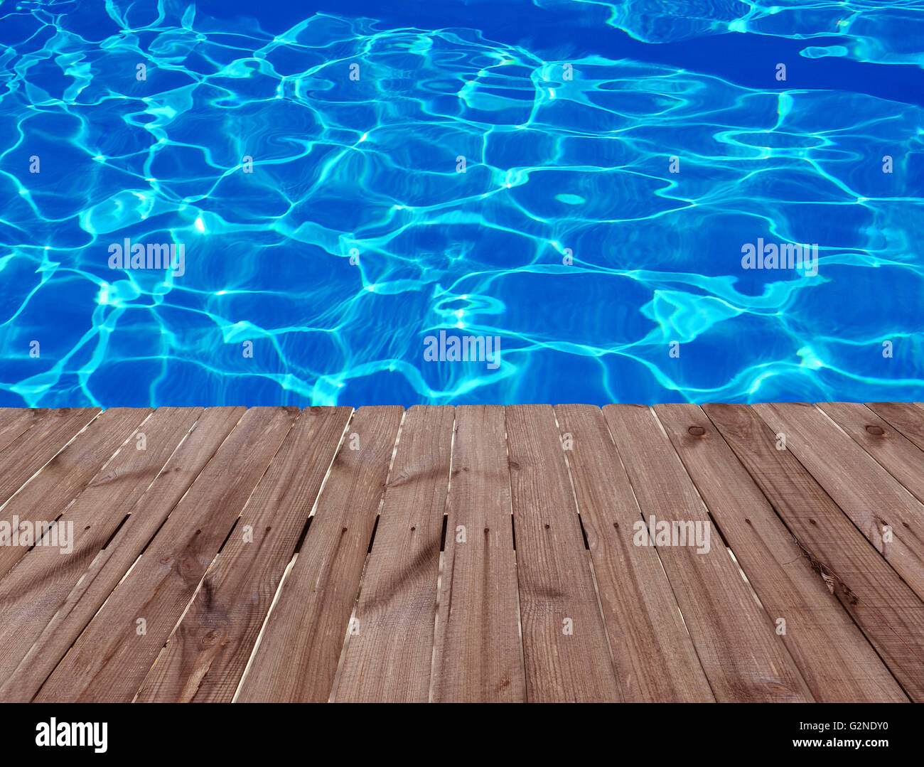 Old wooden floor and blue water in swimming pool Stock Photo