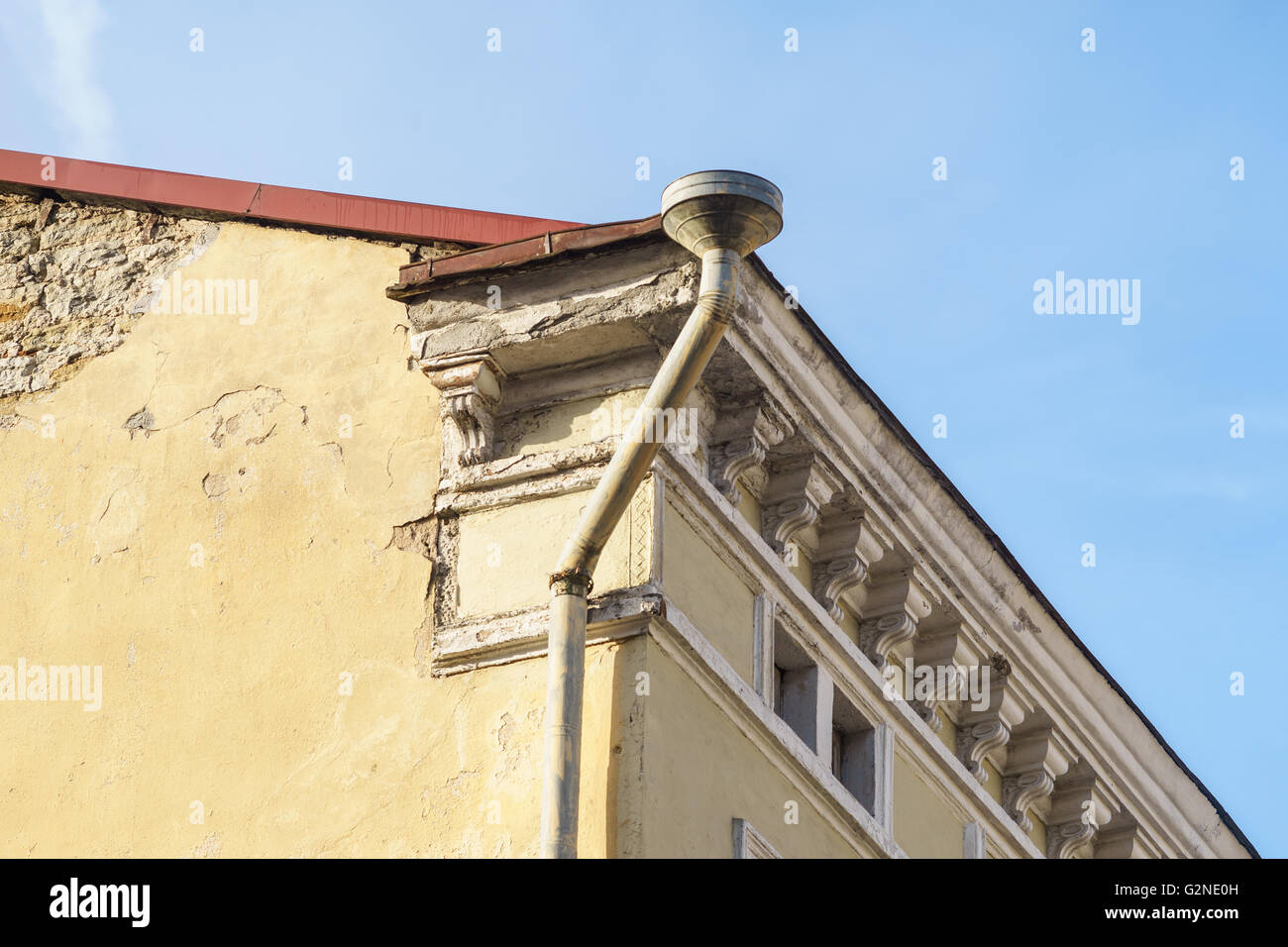 Rain gutter and downspout on corner of old style house Stock Photo