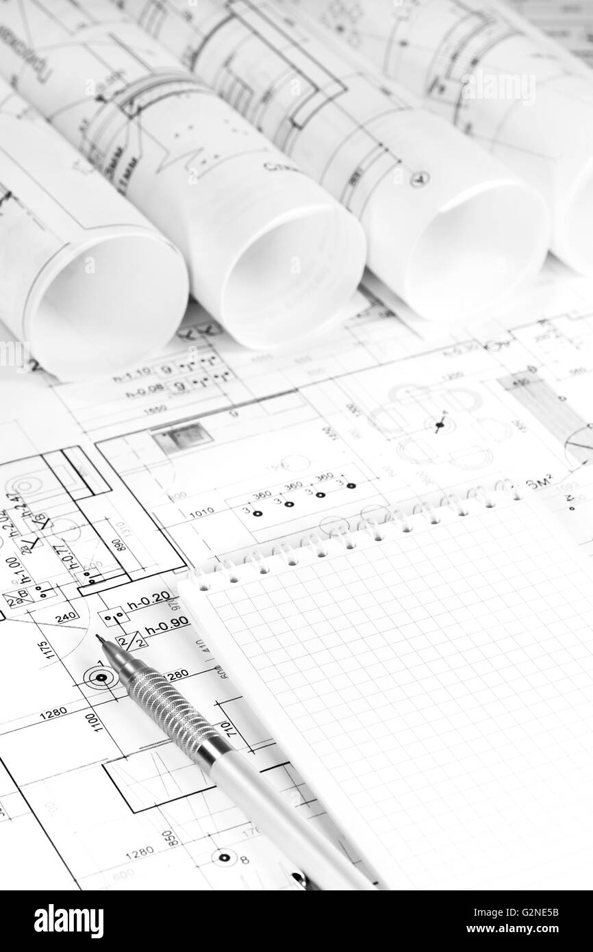 Architectural background with rolls of technical drawings and work tools Stock Photo