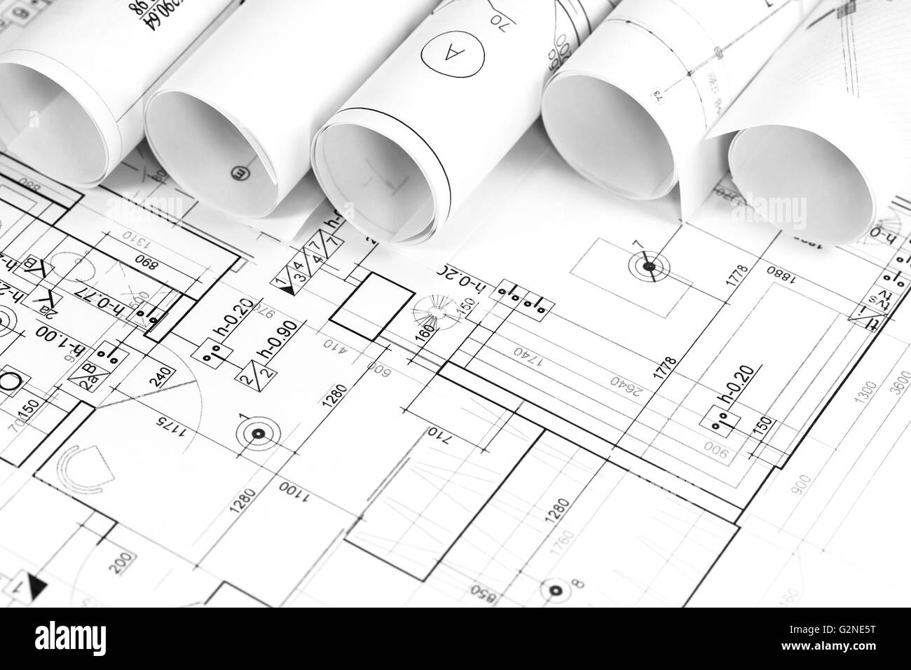 Architectural background with rolls of technical drawings and work