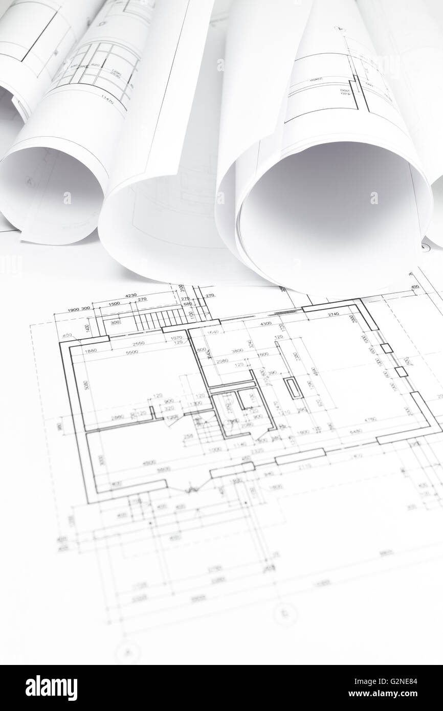 Architectural blueprint with bunch of rolled up building plans Stock Photo
