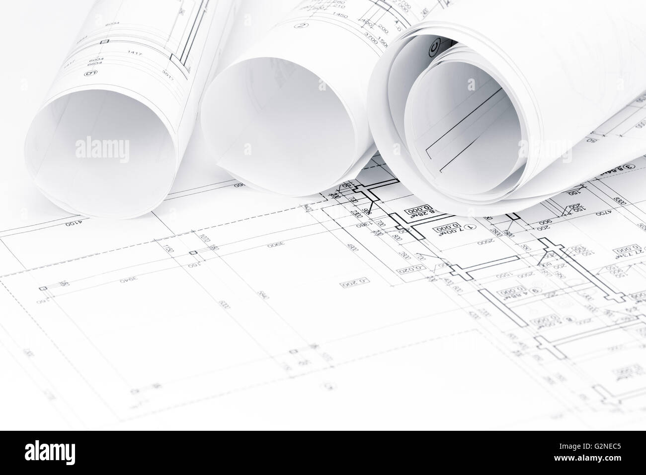 architectural background with floor plans and rolls of technical drawings  Stock Photo - Alamy