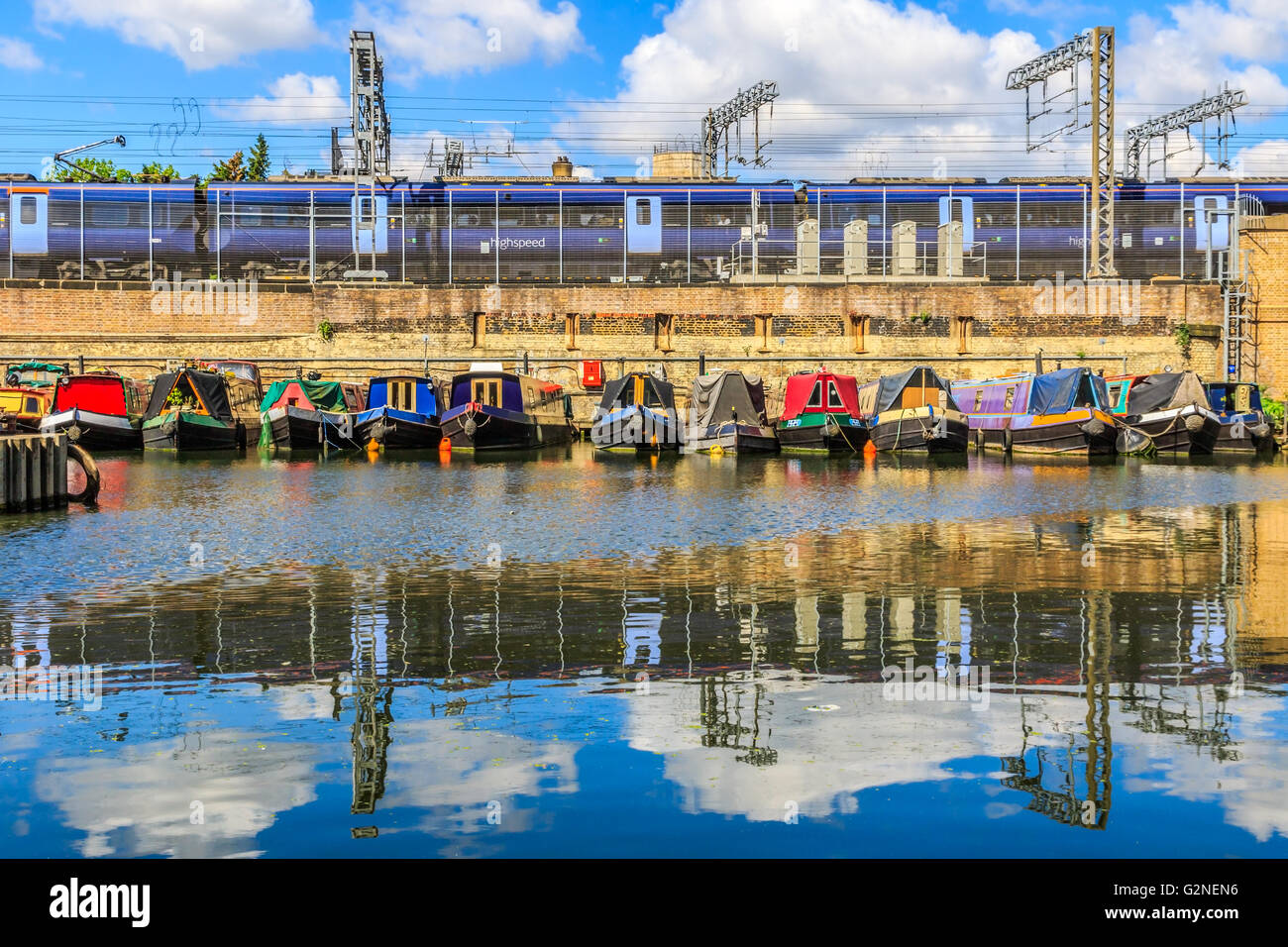 Rows of houseboats and narrow boats on the canal banks at St Pancras Yacht Basin, part of the Regent's Canal in London Stock Photo