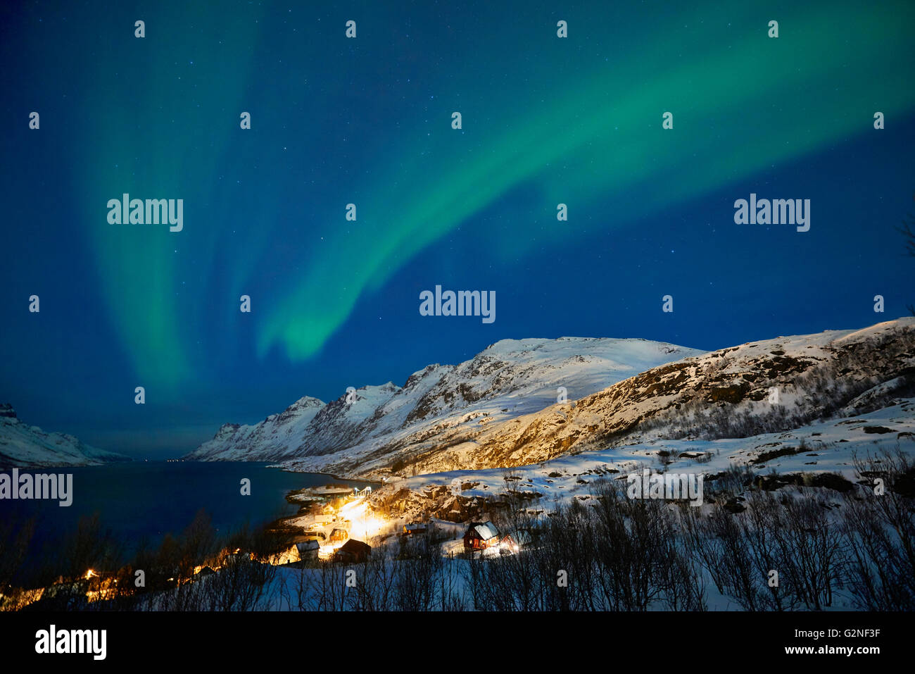 Aurora Borealis or northern lights over winter landscape in fjord of Ersfjordbotn, Tromsö, Troms, Norway, Europe Stock Photo