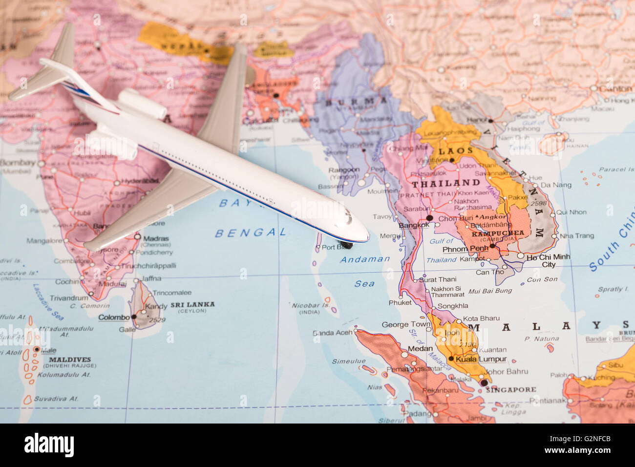 Miniature of a passenger airplane flying over the map of Thailand from north west. Conceptual image for travel and tourism Stock Photo