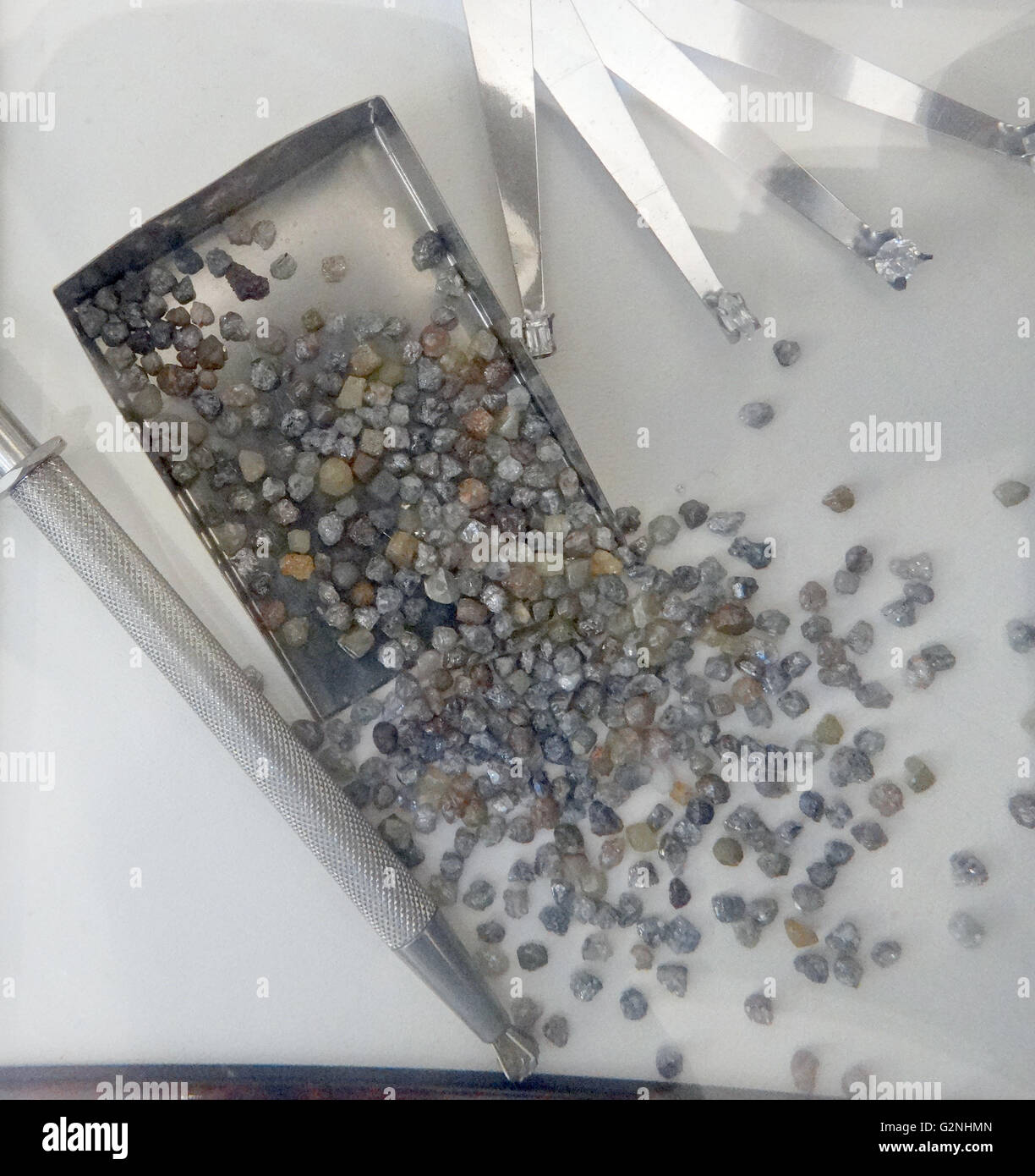 Sample of diamonds in their raw state. They can be typically yellow, brown or Gray to colourless. Less often blue, green, black, translucent white, pink, violet, orange, purple and red in colour before being processed. Dated 2014 Stock Photo