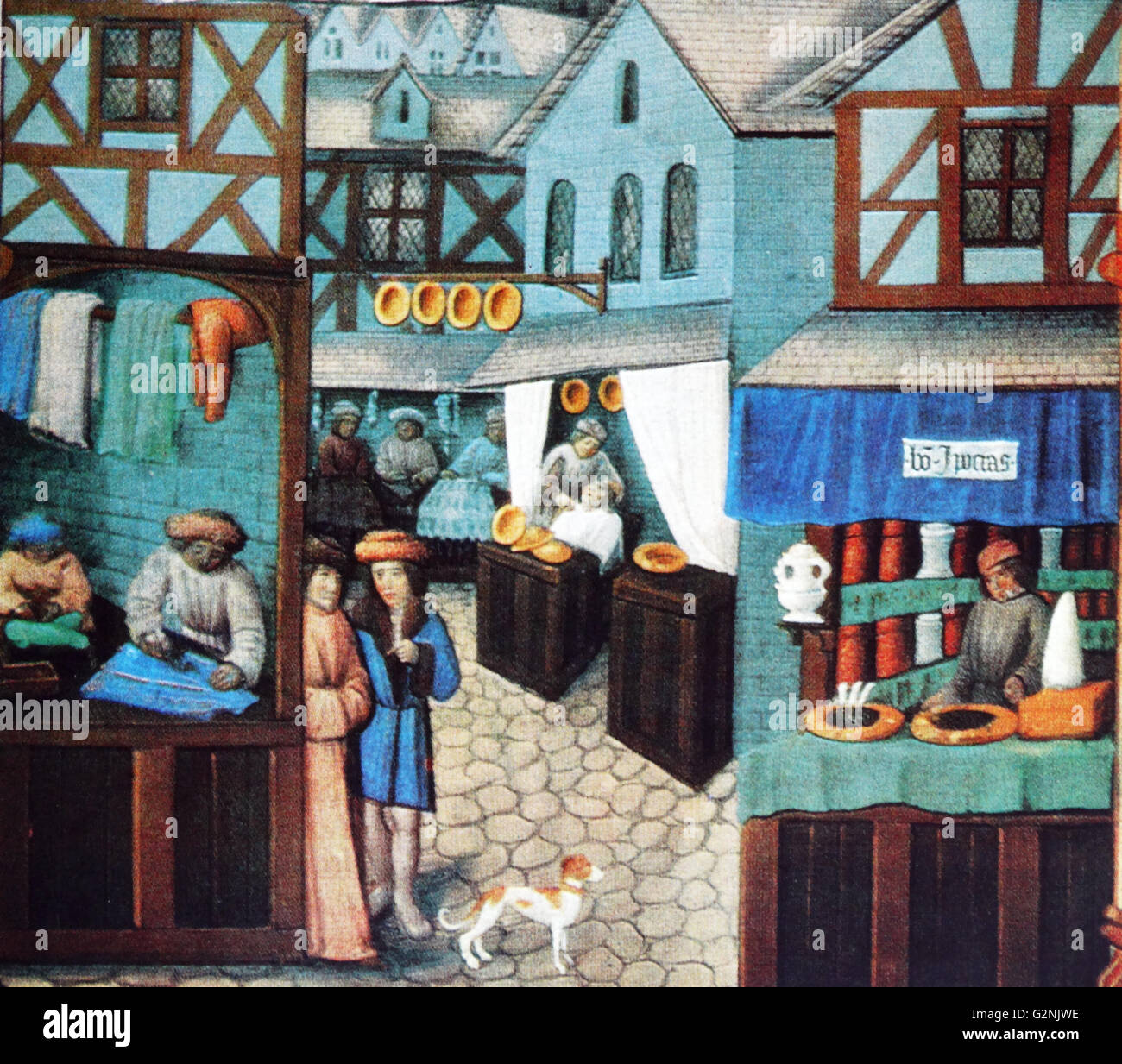 Miniature depicting urban Mediaeval life. On a paved street there are a variety of shops including a tailor, barber, furrier and druggist. Dated 14th Century Stock Photo