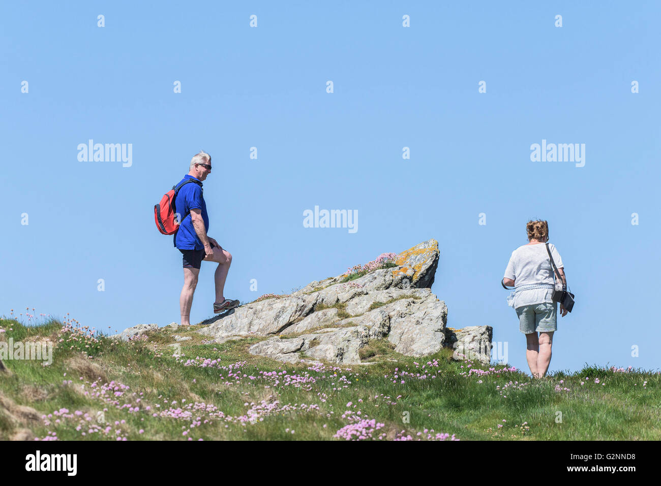 Sunny weather as holidaymakers stand on East Pentire Headland in Newquay, Cornwall. Stock Photo