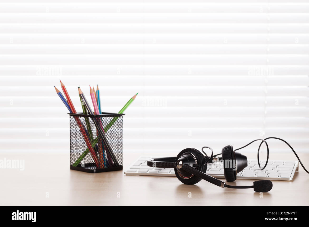 Office desk with headset and pc. Call center support table Stock Photo