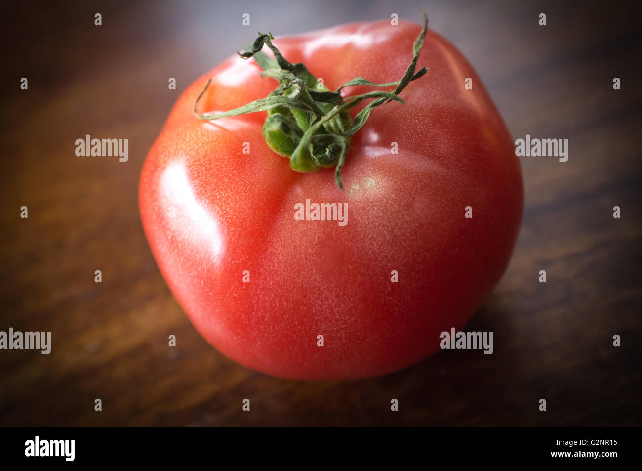 Colorful juicy heirloom or heritage tomatoes on wooden table Stock Photo