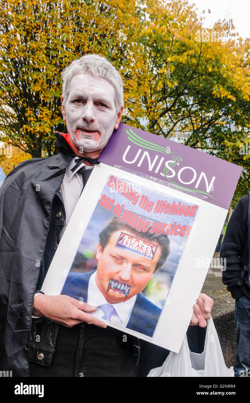 20/10/2012, Belfast - Man dressed as a vampire holding photo of David Cameron. ICTU hold an anti-austerity rally in Belfast. Stock Photo