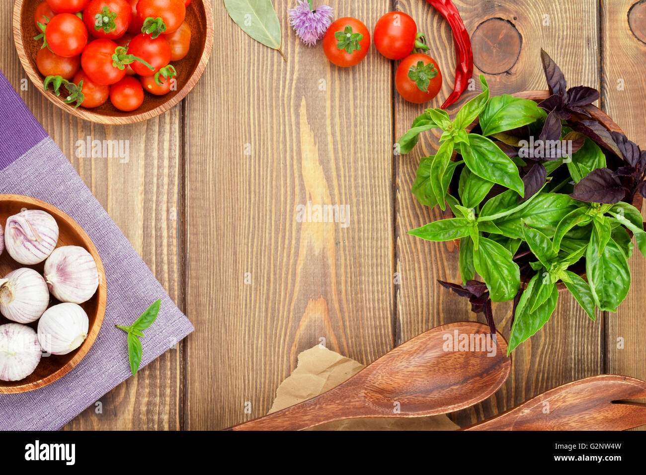 Fresh farmers tomatoes and basil on wood table with copy space Stock ...