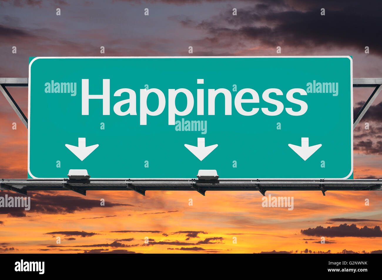 Road to happiness freeway sign with sunrise sky. Stock Photo