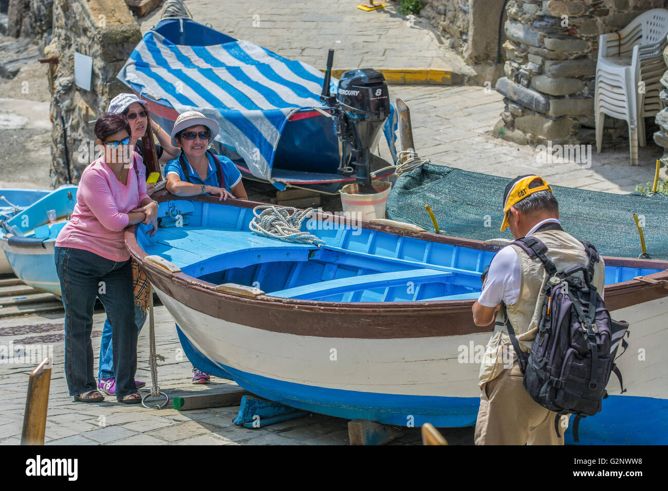 Tourists in the little natural harbour of Riomaggiore (Liguria) Stock Photo