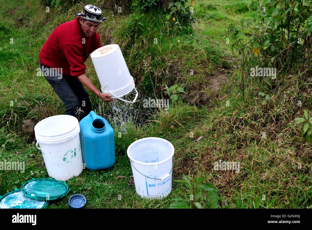 Washing milk container in Pulun ' Las Huaringas '  - HUANCABAMBA.. Department  of Piura .PERU Stock Photo