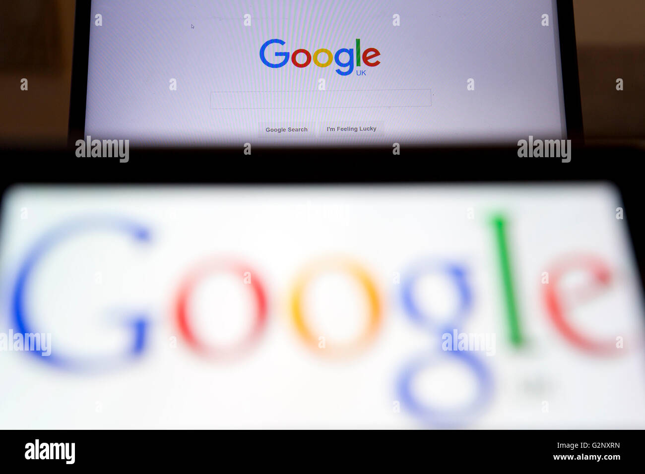 Google UK search engine logos are pictured on phone and laptop screens