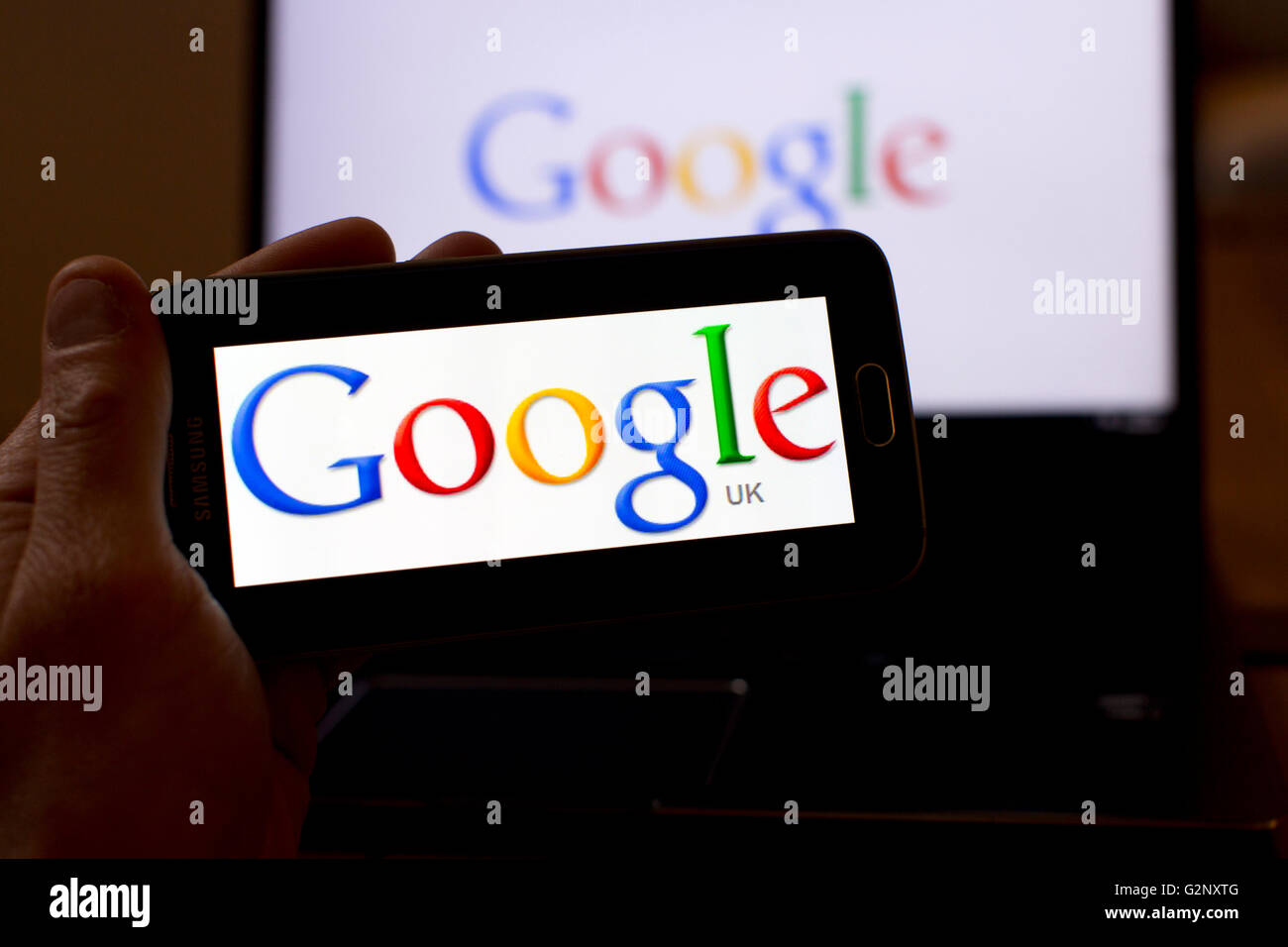 Google UK search engine logos are pictured on phone and laptop screens