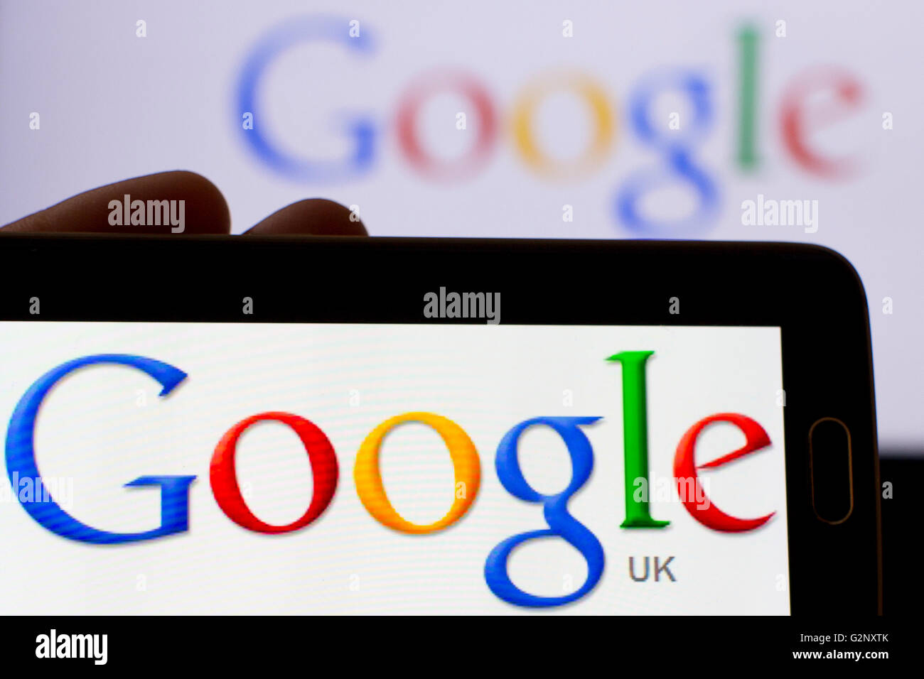 Google UK search engine logos are pictured on phone and laptop screens