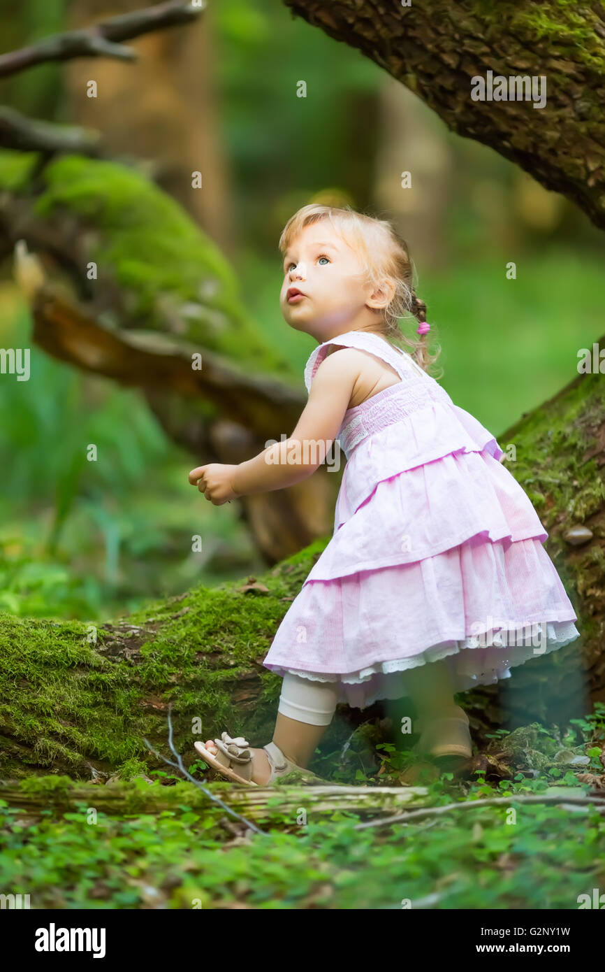 Little girl in the forest Stock Photo - Alamy