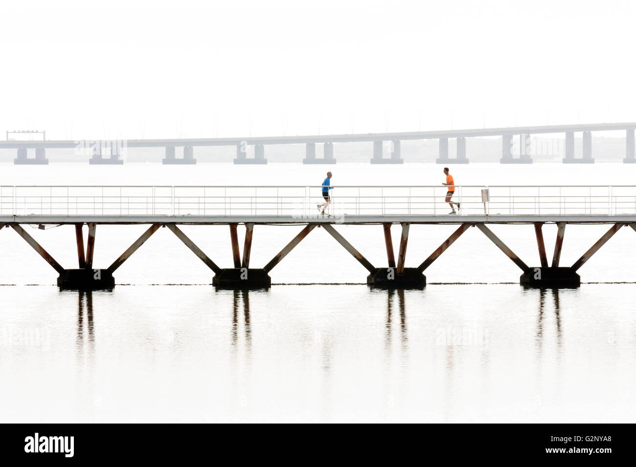Joggers on bridge in Parque das Nacoes, Lisbon Stock Photo
