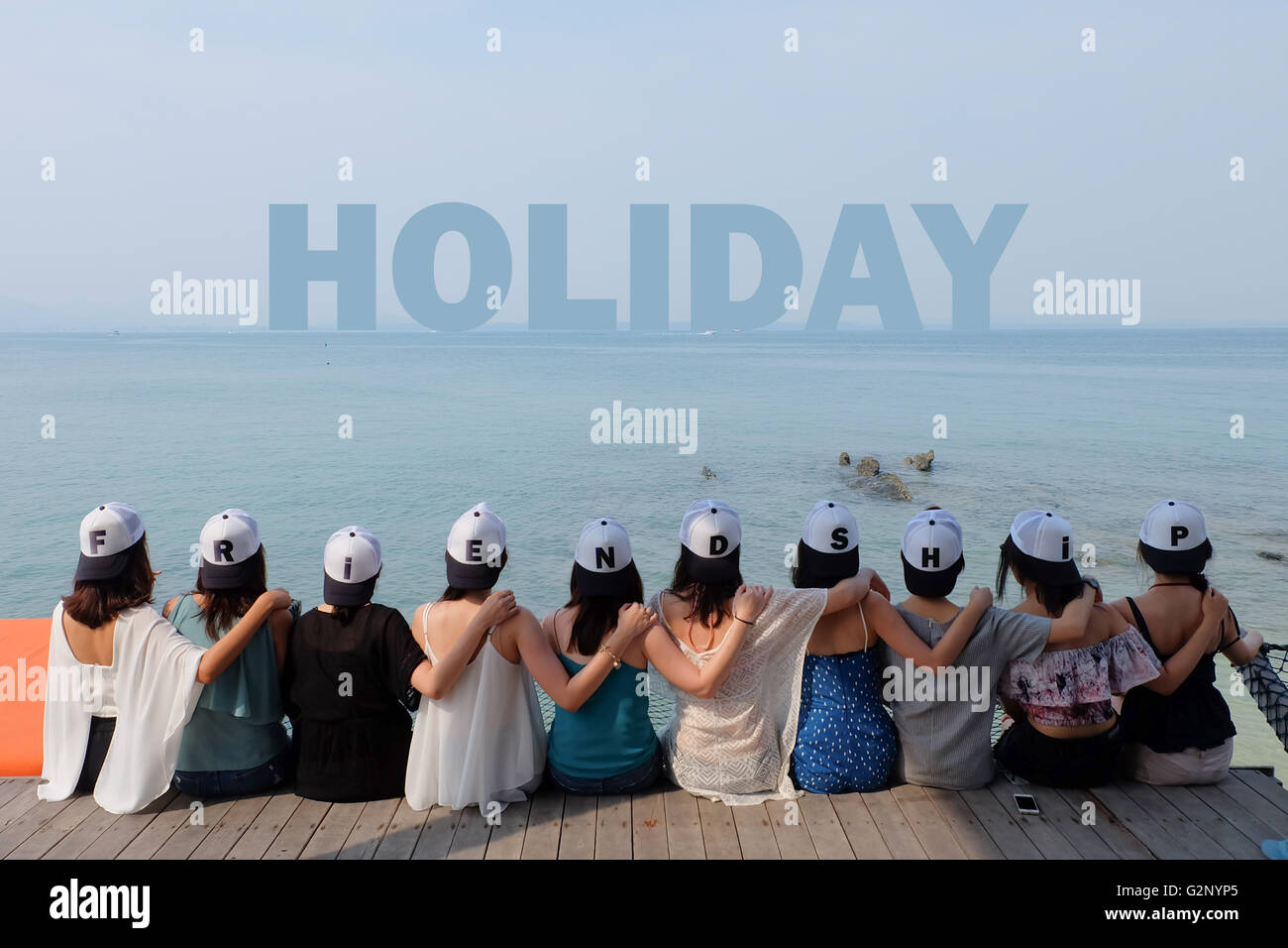 group of ten women friends sit hug together look HOLIDAY sea sky ...