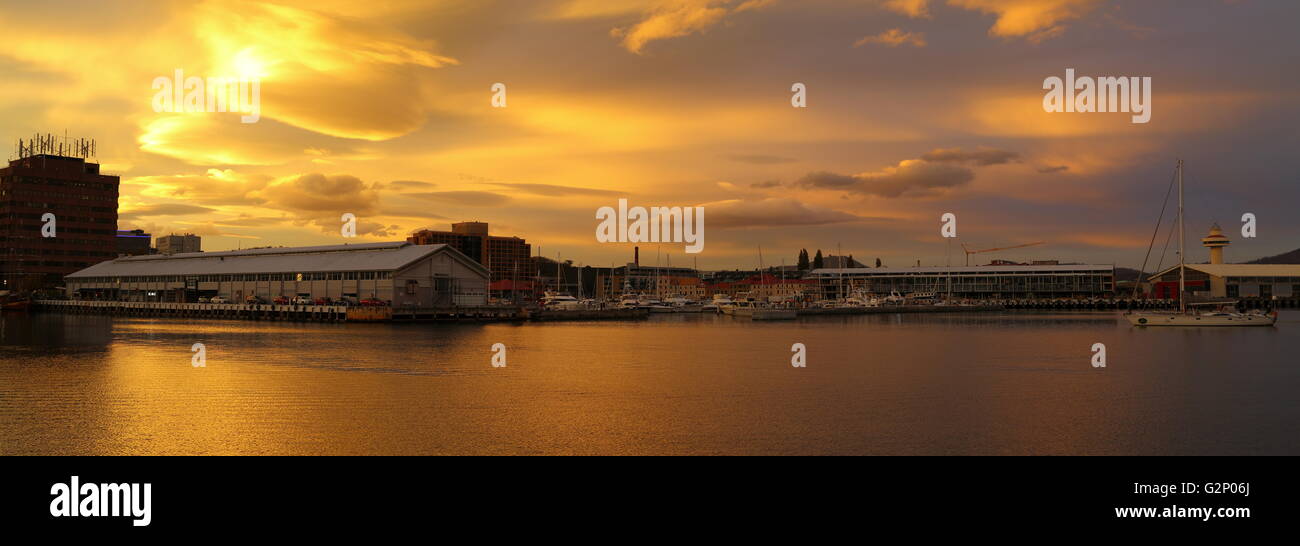A panorama of a vivid sunset over Elizabeth Street Pier and Sullivans Cove - Constitution Dock, Hobart, Tasmania, Australia. Stock Photo