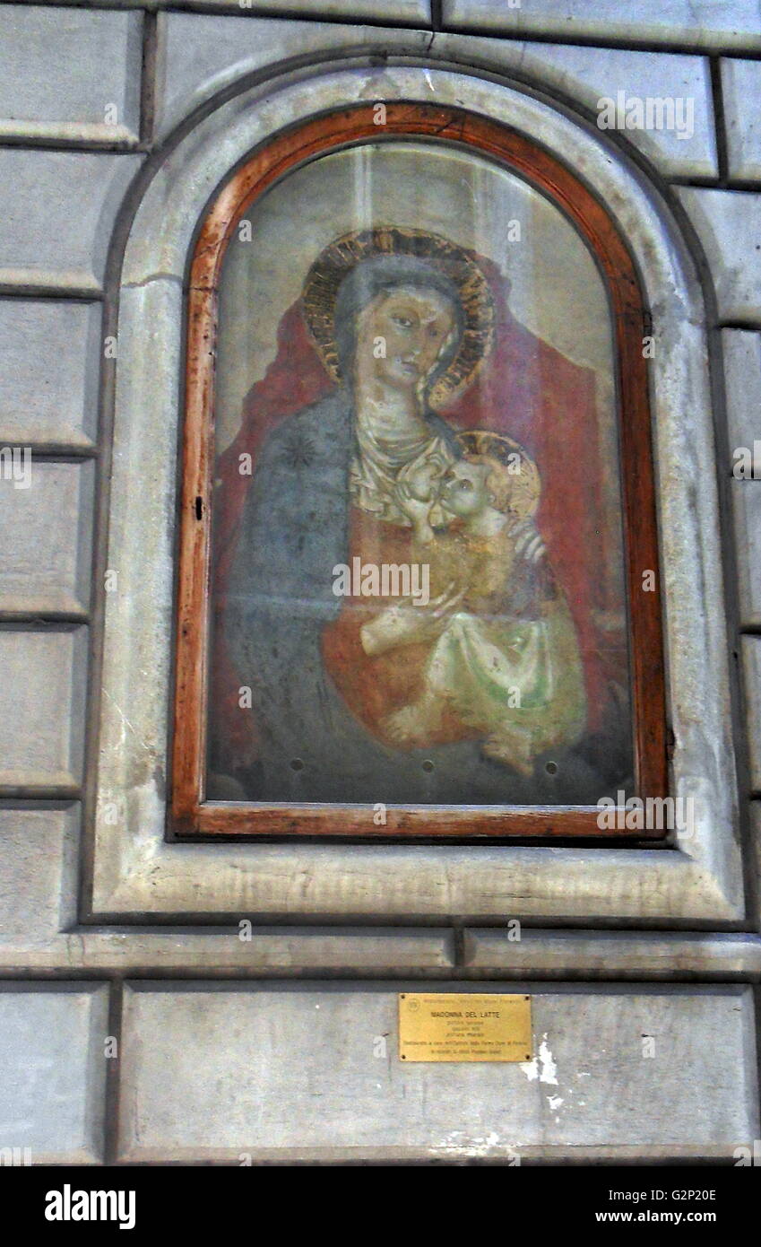 Madonna del Latte, painted mural on a wall in Florence, Italy. circa 14th century. A nearby plaque bears the inscription: 'In memory of Anita Poggiali Buyet'. Stock Photo