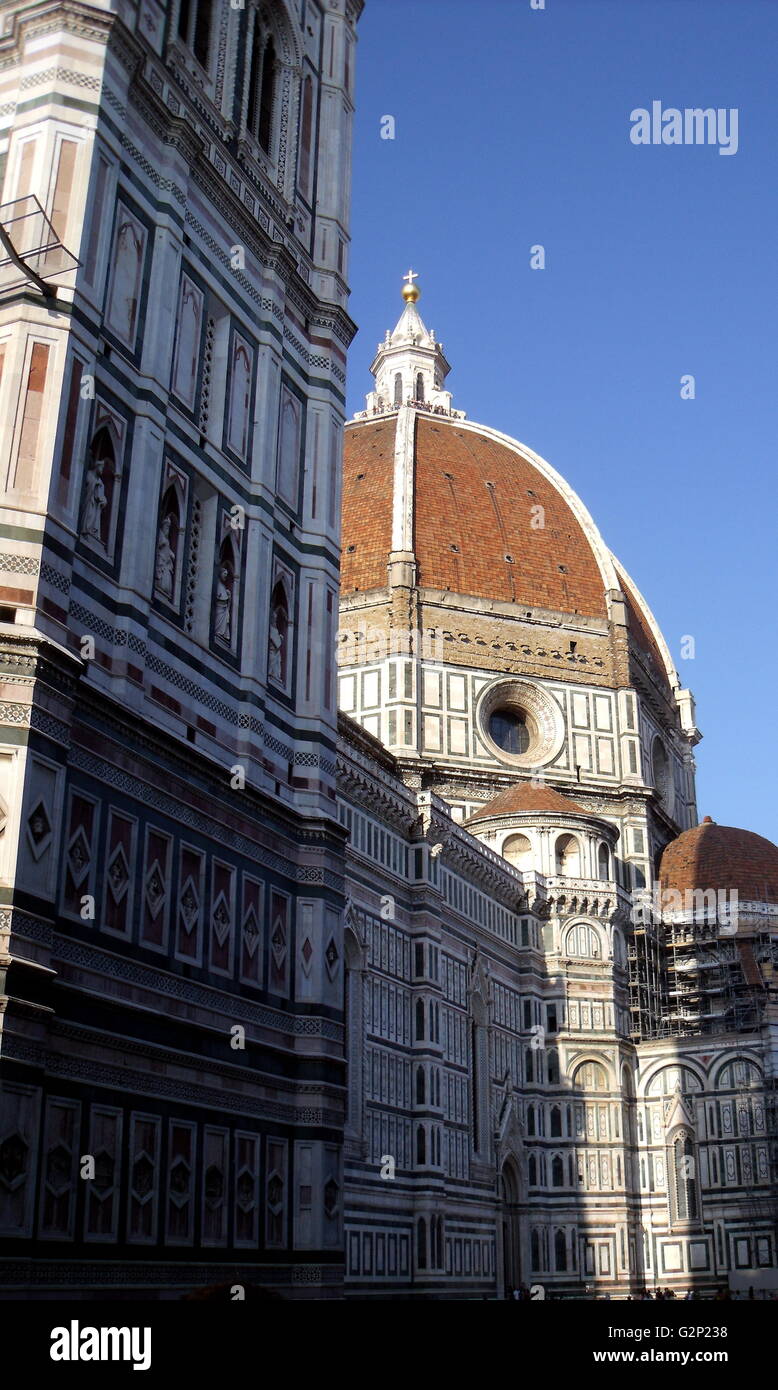 The dome from the Basilica di Santa Maria del Fiore, more commonly called the 'Duomo'. Florence, Italy. Started in 1296 based on Arnolfo di Cambio's design, but was not complete until 1436 when Filippo Brunelleschi engineered the dome. One of Italy's largest churches. The dome itself is octagonal, and uses a double shell design, made of sandstone and marble. Atop the dome sits a lantern with a copper ball and cross at it's peak. Stock Photo