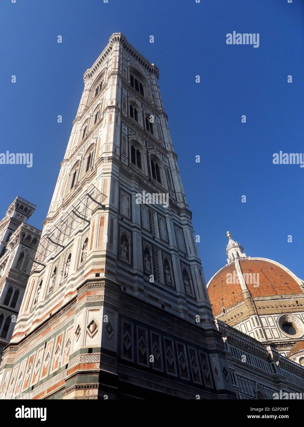 The tower from the Basilica di Santa Maria del Fiore, a building more commonly known as the 'Duomo'. Florence, Italy. Started in 1296 based on Arnolfo di Cambio's design, but was not complete until 1436 when Filippo Brunelleschi engineered the dome. One of Italy's largest churches. Stock Photo