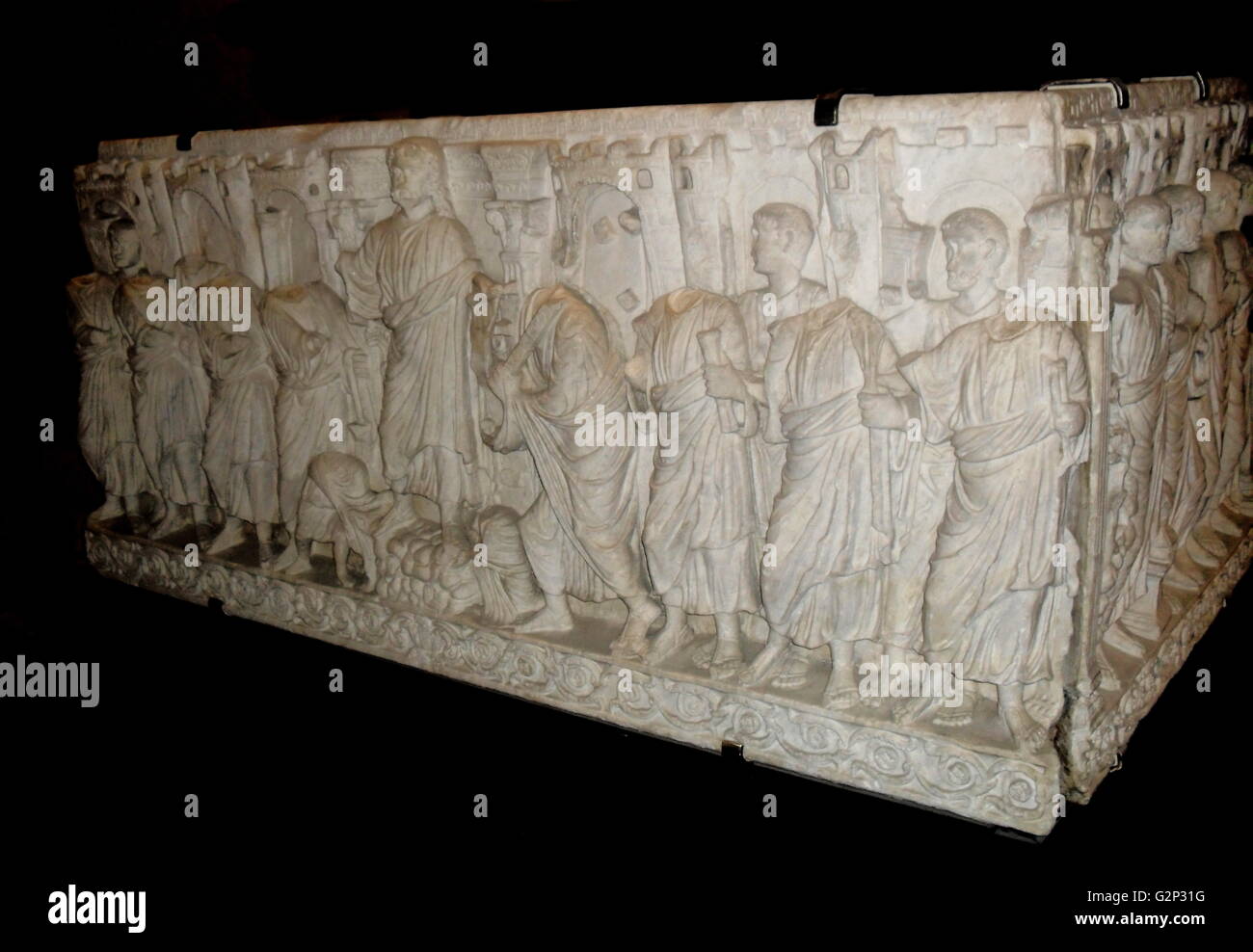 Roman Sarcophagus. Last decades of the 4th century. Detailed with a relief of crenelated towers, Christ and his followers, and Moses receiving the 10 commandments. Stock Photo