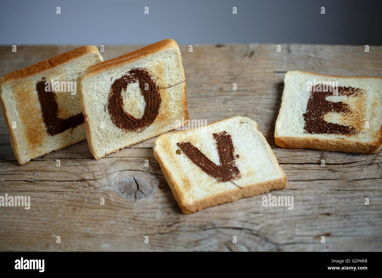 Toast Bread with the Word LOVE painted with hazelnut chocolate spread Stock Photo