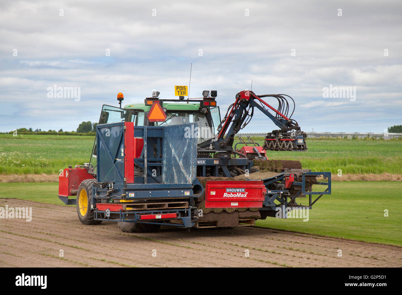 Brouwer RoboMax Automatic Roll Sod Harvester harvesting turf in