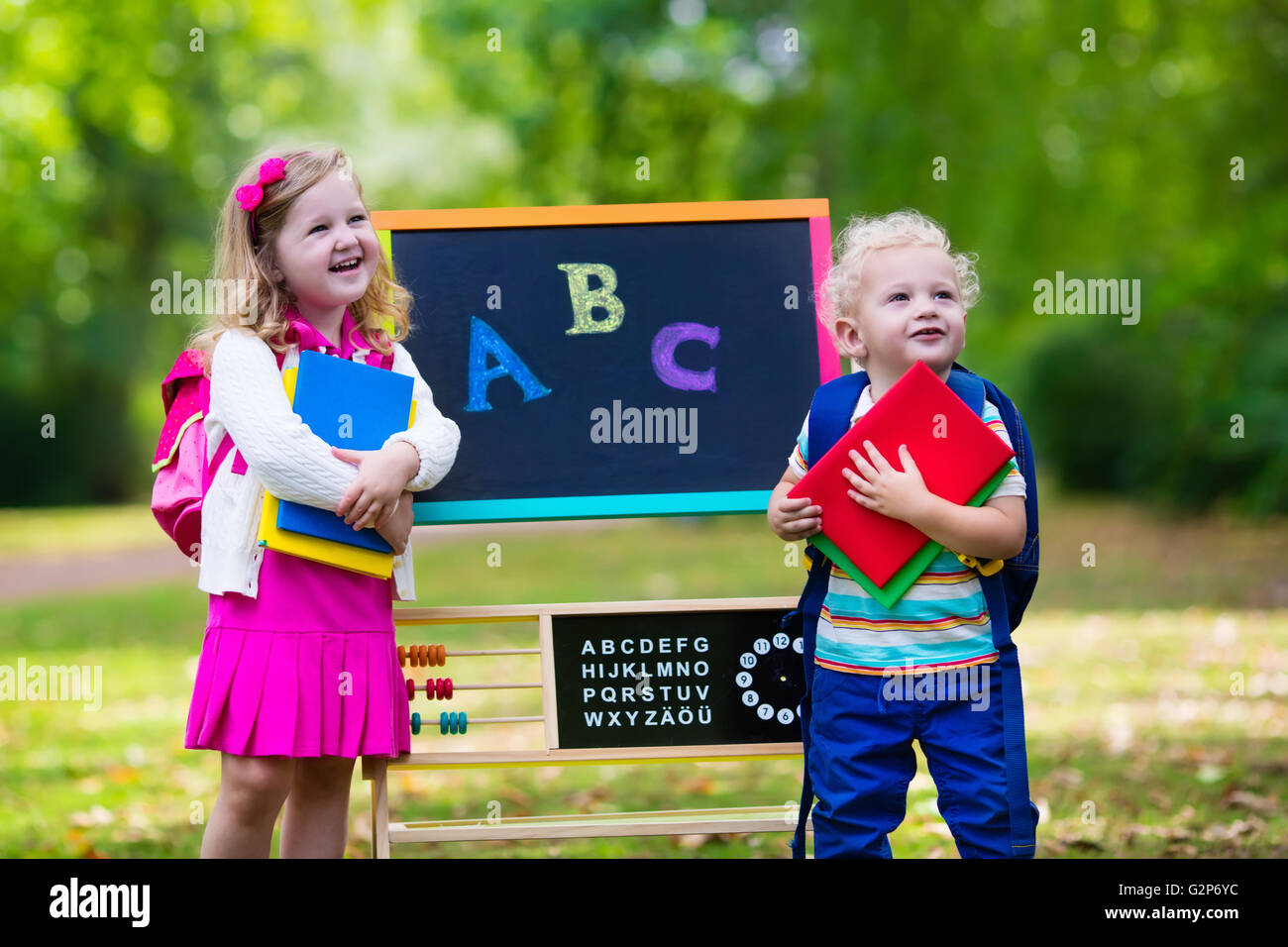 Children happy to be back to school. Preschooler girl and boy with ...