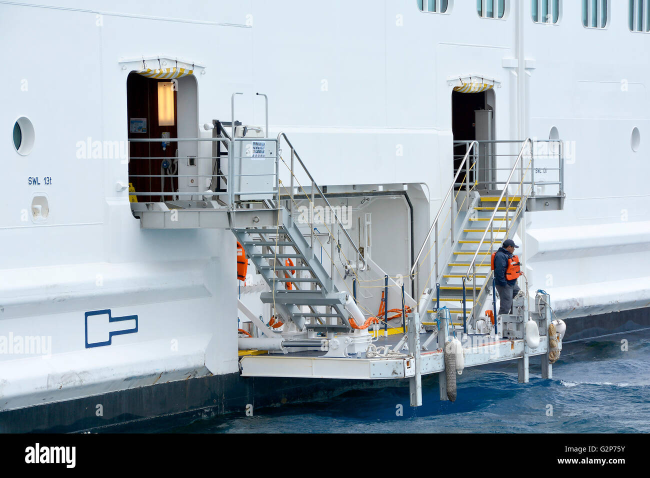 Cruise Ship Liner Crew Member On Hydraulic Fold Out Boarding Docking Platform For Passengers Departing Returning By Tender From Shore Excursions Stock Photo Alamy
