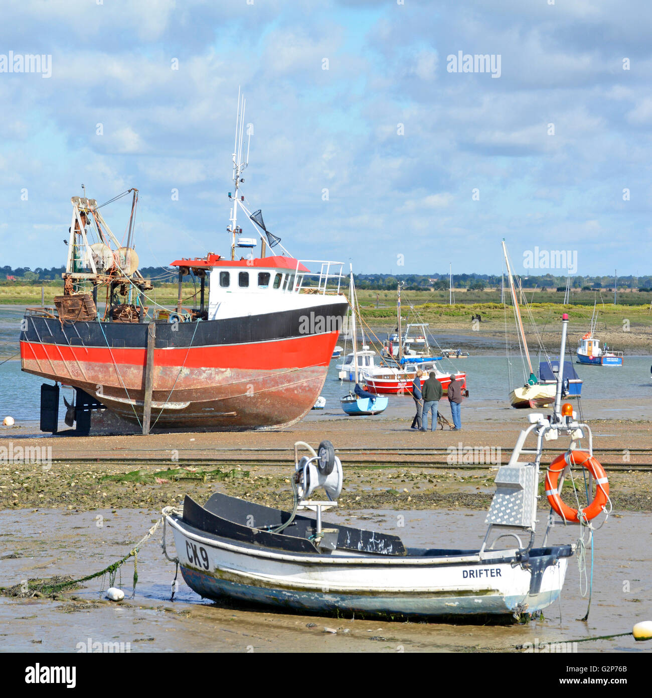 Boats in low tide coastal landscape at West Mersea on Mersea Island at