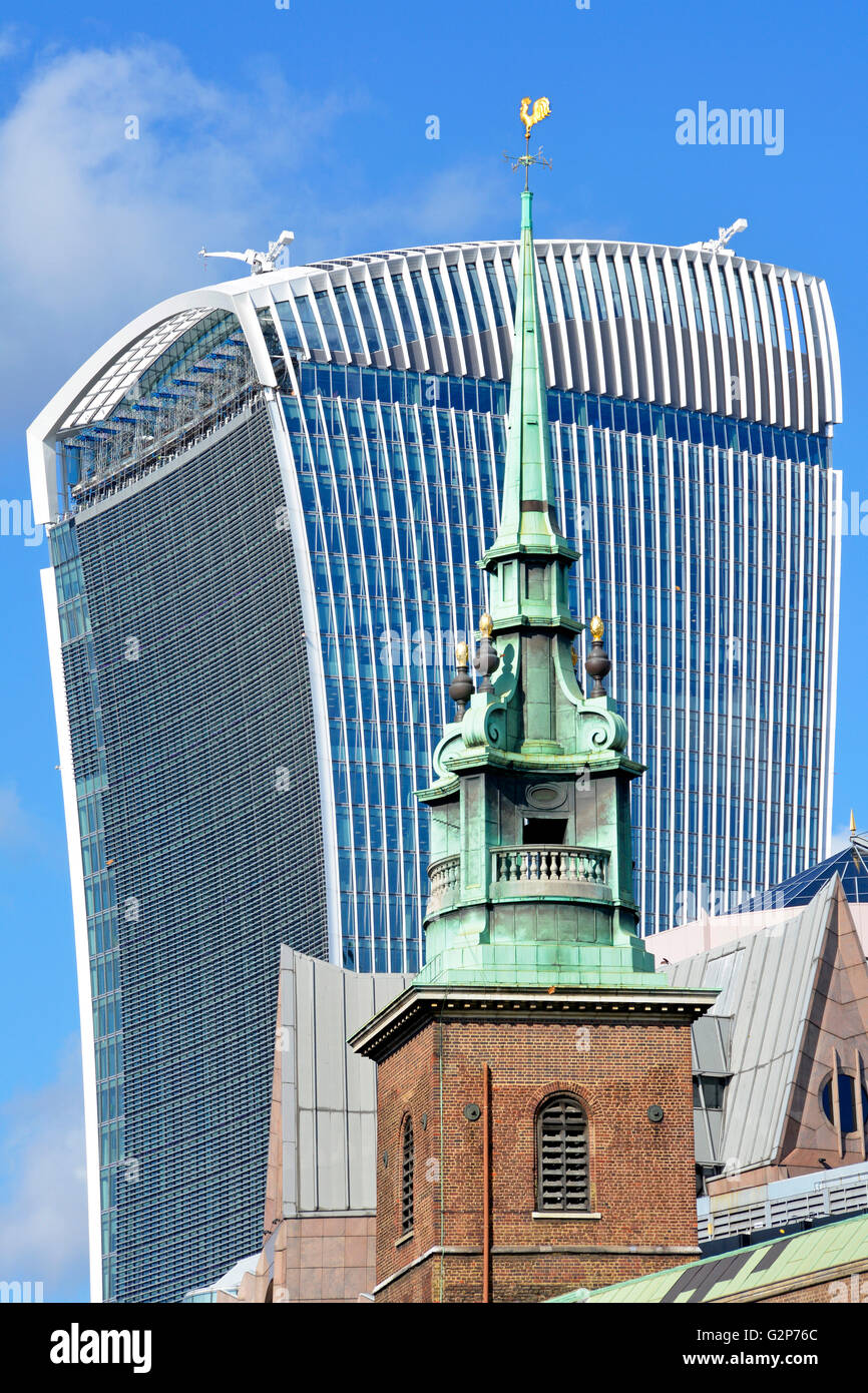 Green patina copper clad tower of All Hallows church Tower Hill in City of London with Walkie Talkie building at 20 Fenchurch Street England UK beyond Stock Photo