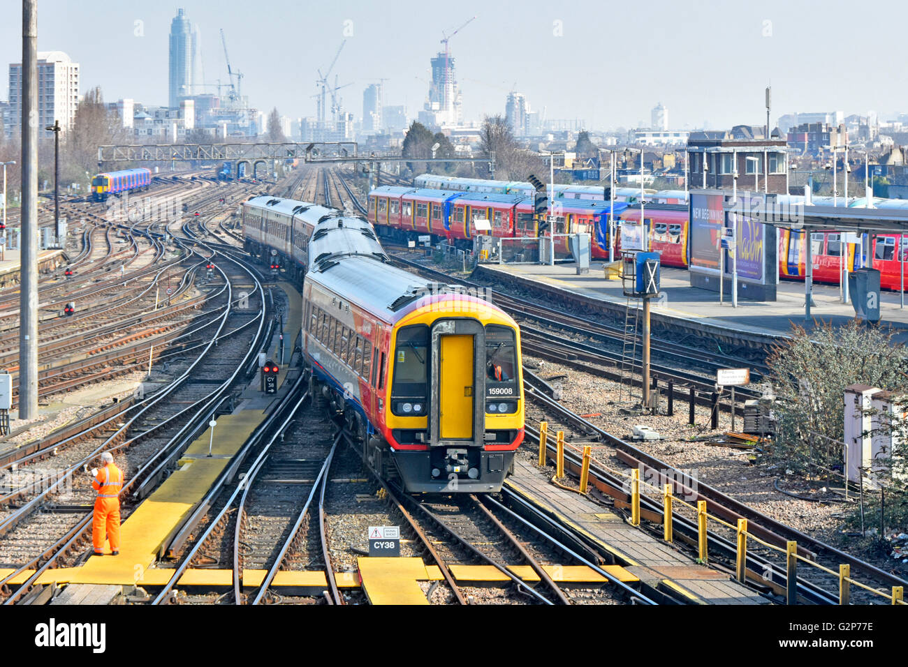 Clapham Junction train station urban landscape train tracks & distant London skyline with South West Trains passenger service returns to depot at  UK Stock Photo