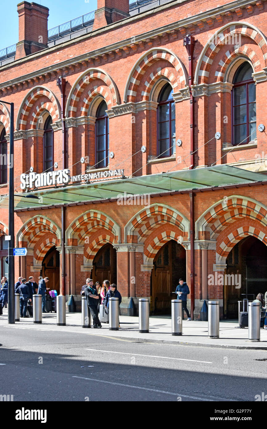 Renovated brick arches at entrance for Euro Star services at St Pancras International train station in London UK with security bollards along pavement Stock Photo