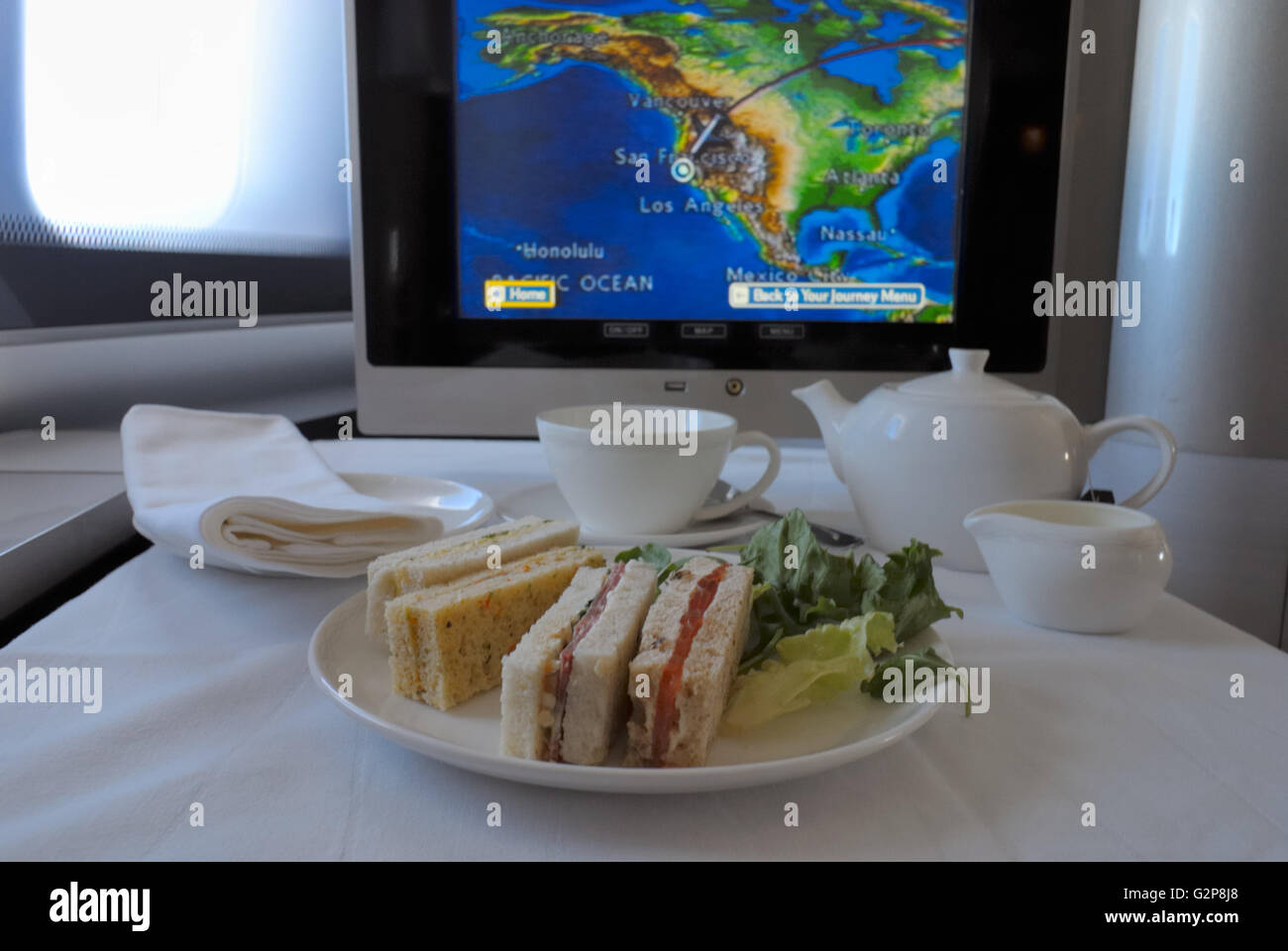 Afternoon Tea (served before arrival) in the New First Class of British Airways BA, Boeing 747-400 (above North America) Stock Photo