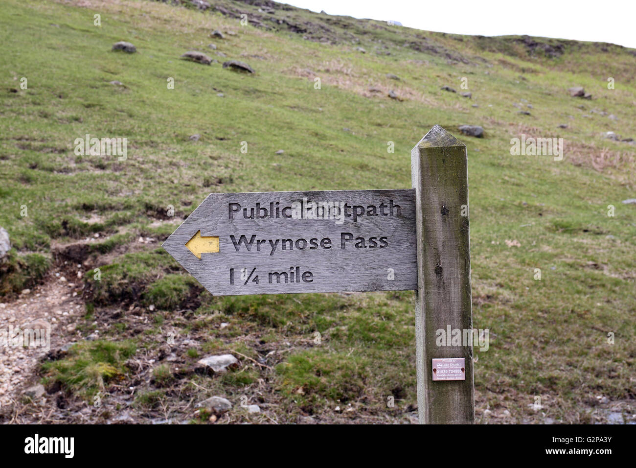 Wooden signpost  showing the way to Wrynose Pass Stock Photo