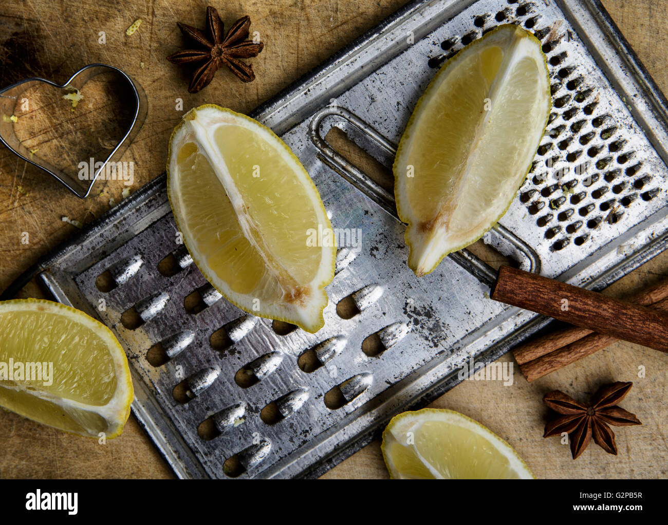 Fresh Lemon with metal grater on blue board Stock Photo