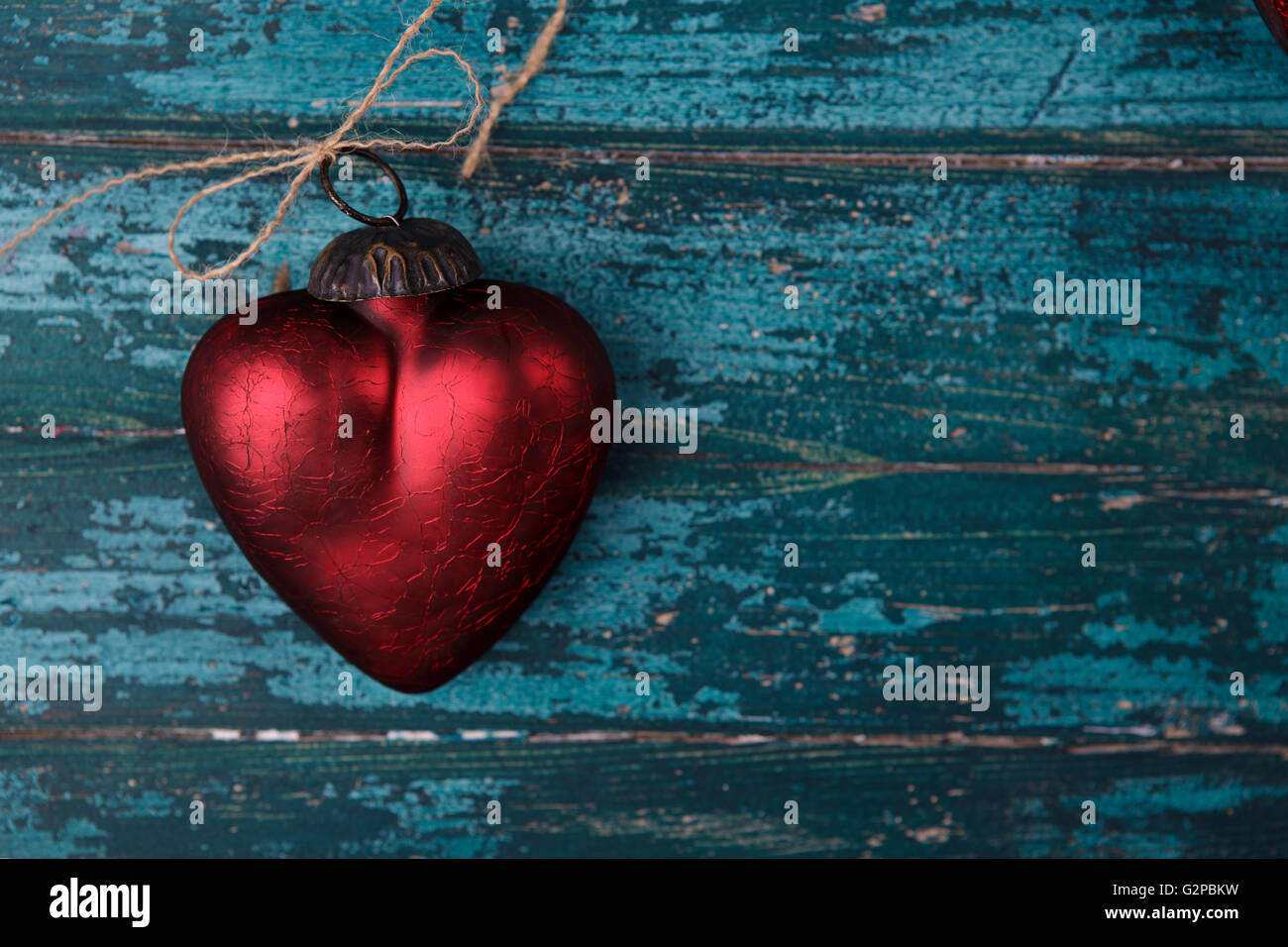 Bright crimson red hearts on cyan colored wooden board Stock Photo