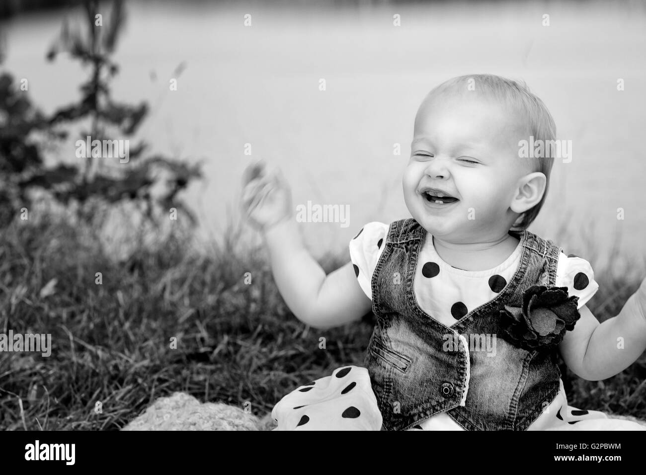 Portrait of a small baby girl at a Lake with blue balloon Stock Photo