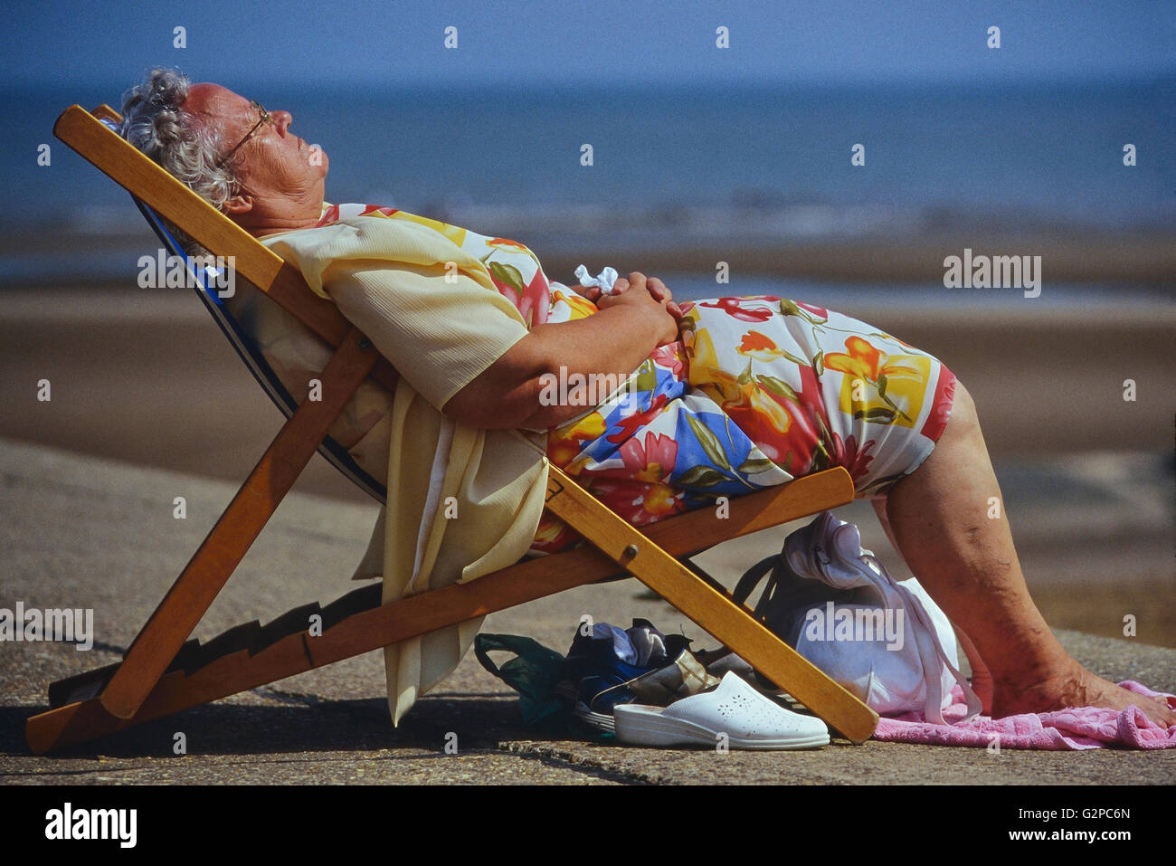 A lady relaxing in a deckchair. UK Stock Photo