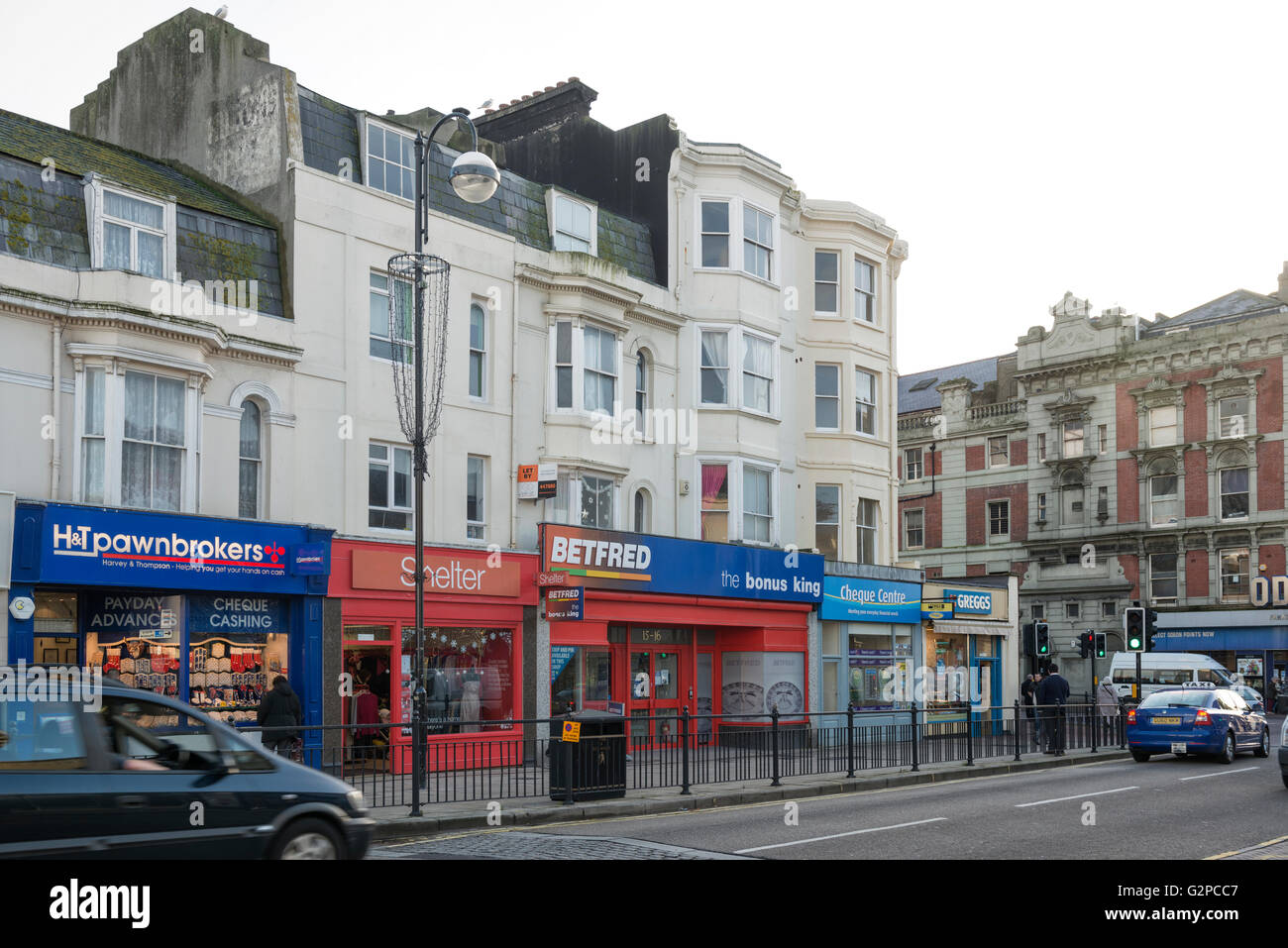 Queen's Road shops including a pawnbrookers, Shelter, Betfred, Cheque