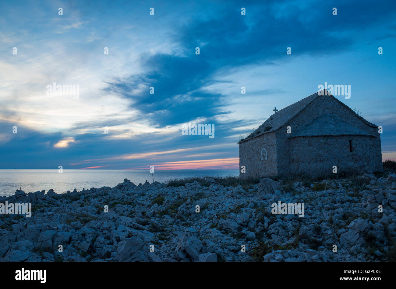 Razanj Croatia Europe. Landscape and nature photo. Adriatic Sea at dawn after sunset. Calm warm summer evening and a small church. Stock Photo