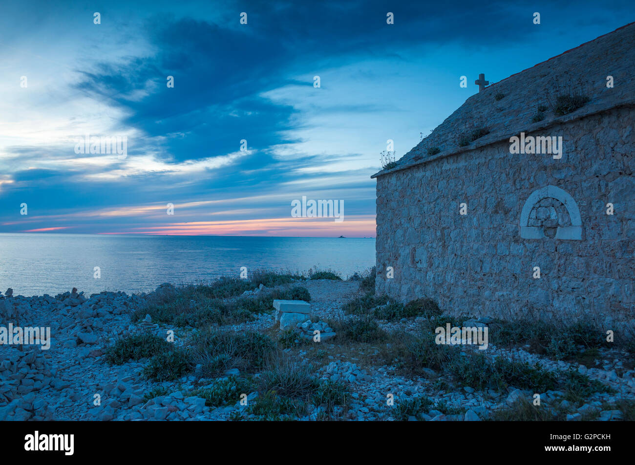 Razanj Croatia Europe. Landscape and nature photo. Adriatic Sea at dawn after sunset. Calm warm summer evening and a small church. Stock Photo