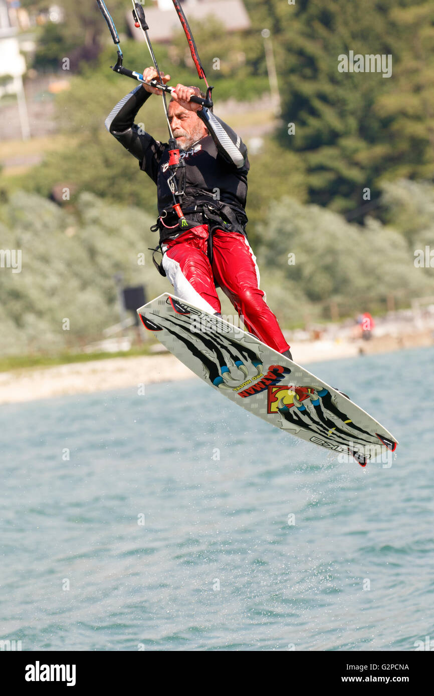 Lake Of Santa Croce, Italy – May 21, 2016: Professional  Kitesurfer jumps over the water during training on Lake of Santa Croce Stock Photo