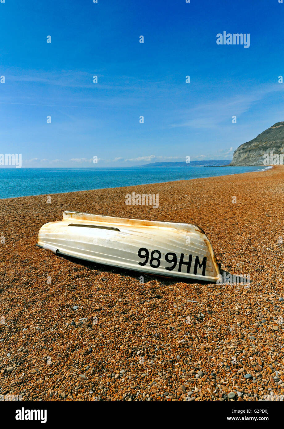 UPTURNED BOAT ON A SEA SHORE IN DORSET Golden Cap Stock Photo