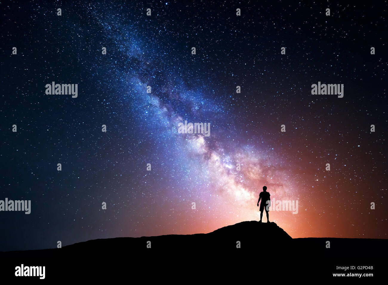 Milky Way. Night sky with stars and silhouette of a standing happy man ...